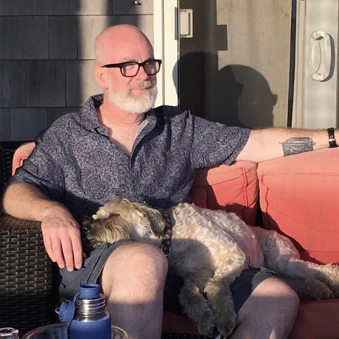 William Shunn lounges in the sun with his dog Ella